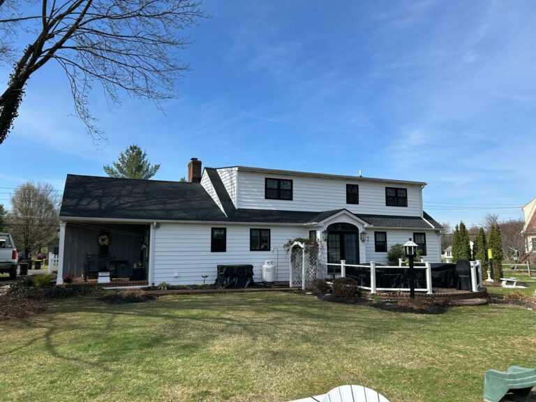 the back of a house with newly installed shingles in perkasie
